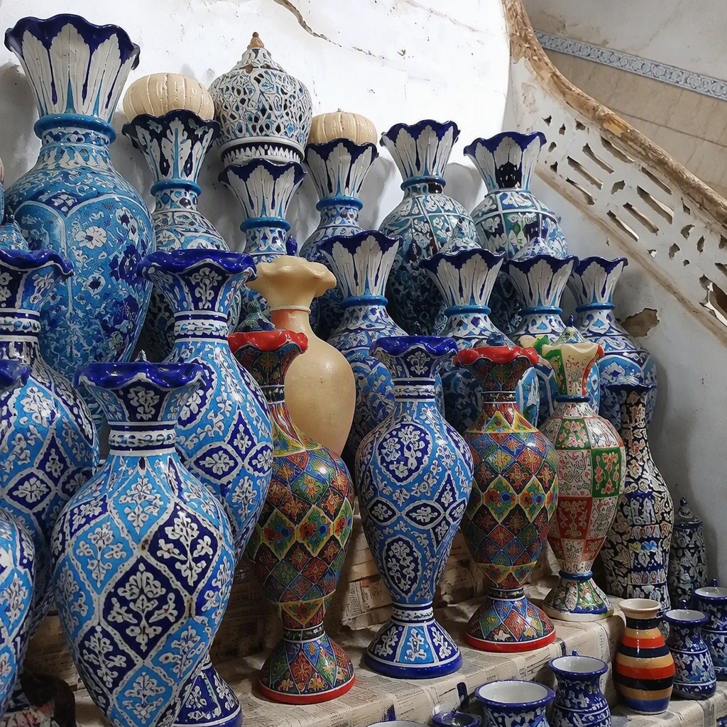 Fluted cobalt vases ranked against the whitewashed wall