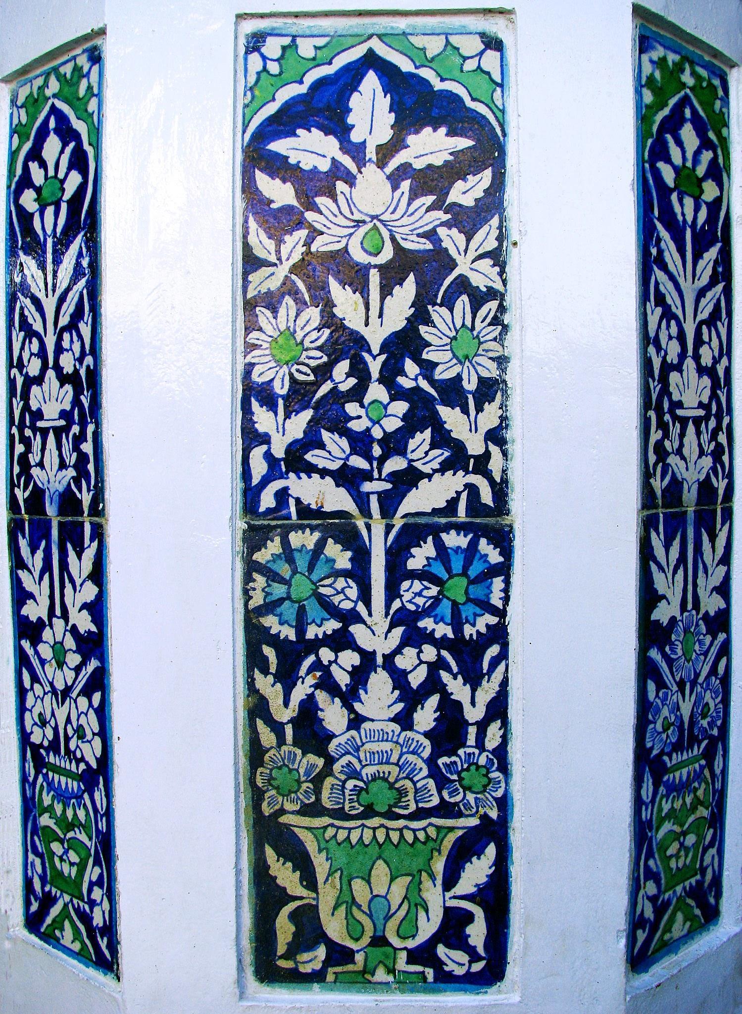 Cobalt, turquoise and green Kashi tile panels with floral motifs on a whitewashed wall