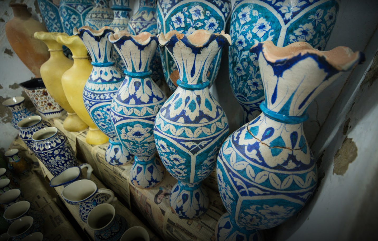 Cobalt and turquoise vases on the workshop shelves